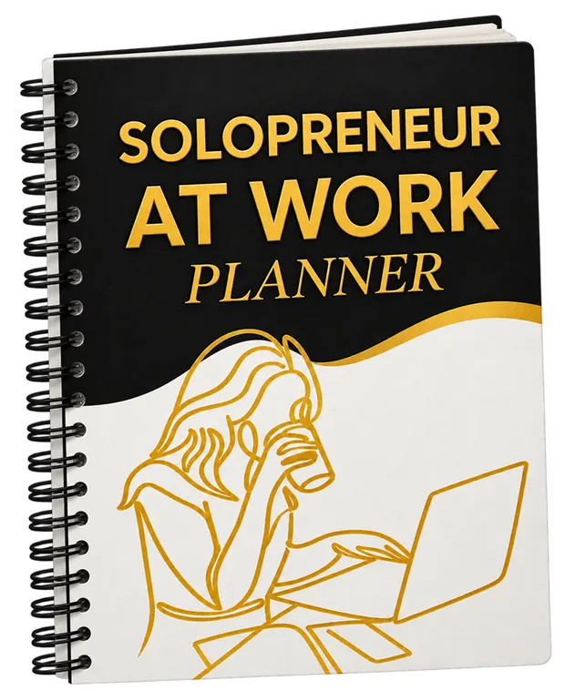 The spiral-bound Solopreneur At Work Planner with a black and white cover, gold foil lettering, and a gold line drawing of a woman working at a laptop